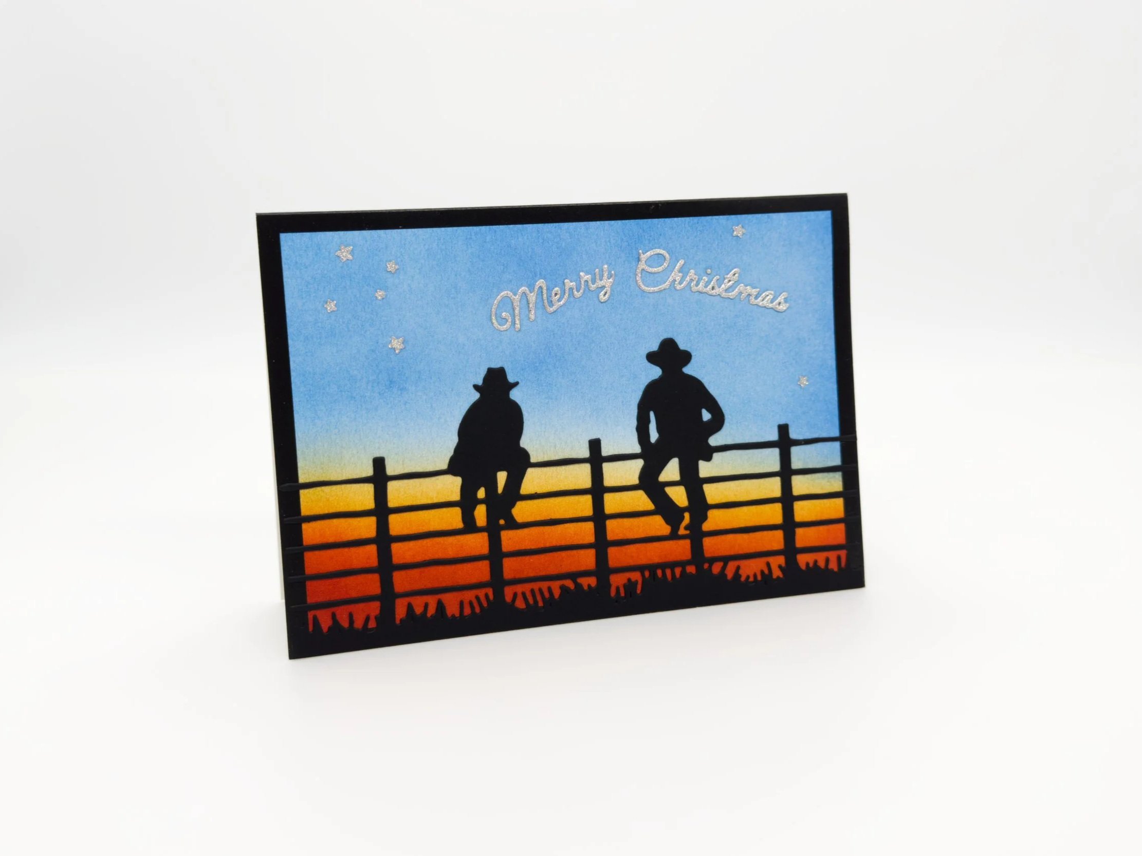 Station Hands sitting on fence at dusk christmas