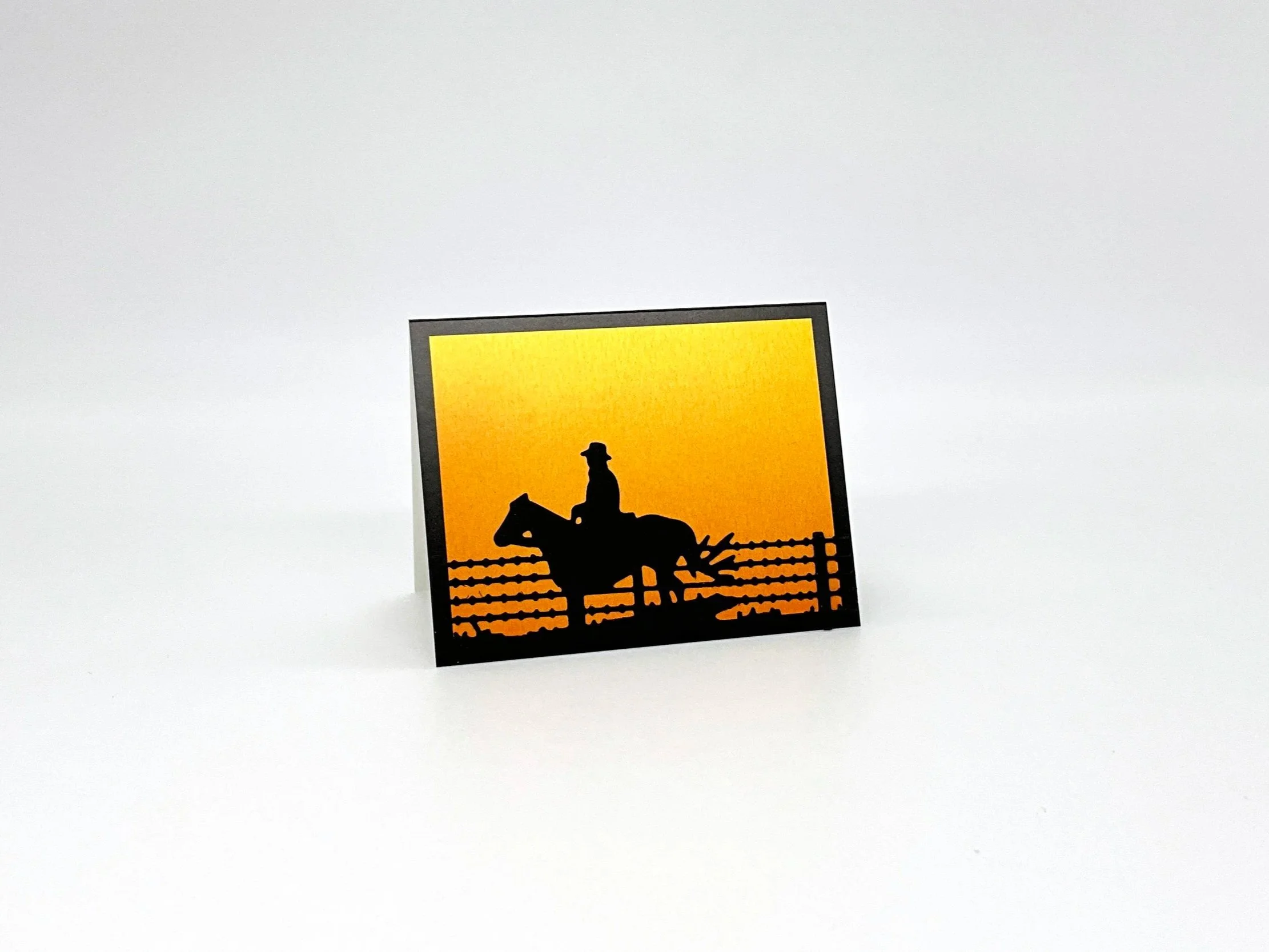 Outback rider on horseback at sunset