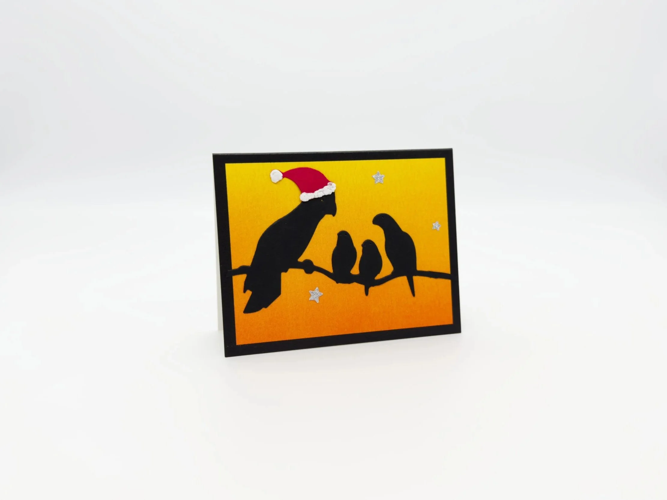 Four birds on branch at sunset christmas