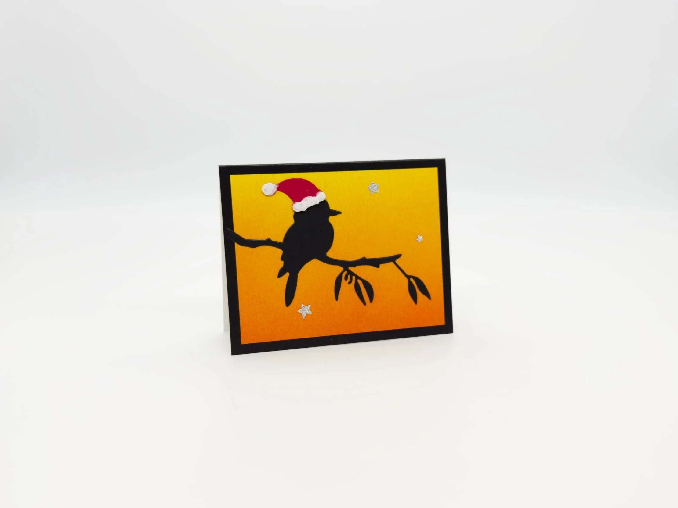 Kookaburra on branch with Santas hat at sunset christmas