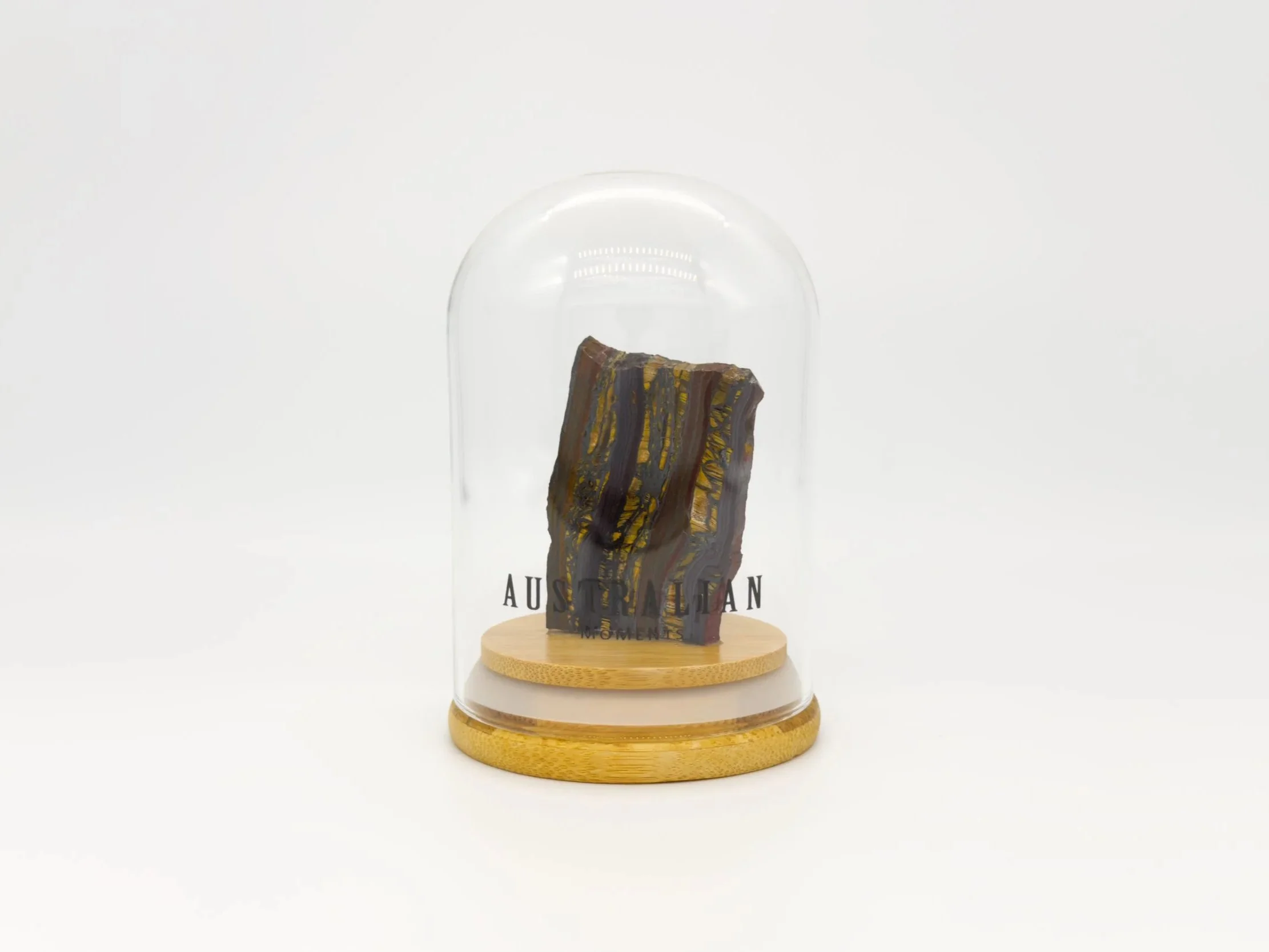 Banded tiger iron section in glass jar