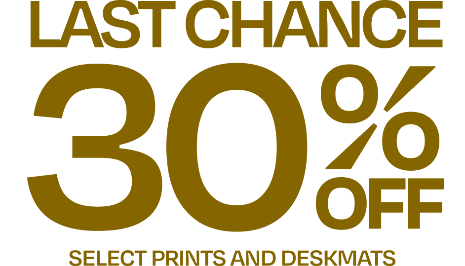 Text advertisement offering a 30% discount on select prints and desk mats. The background is black with large, bold gold text.