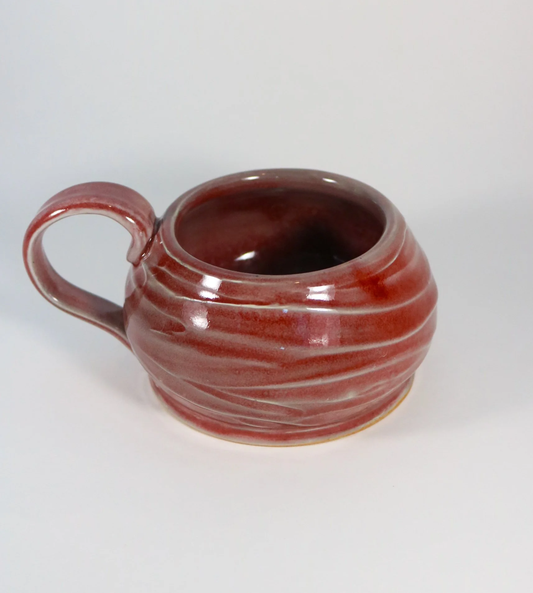 wheel thrown mug | copper red glaze and reduction-fired stoneware | 2025