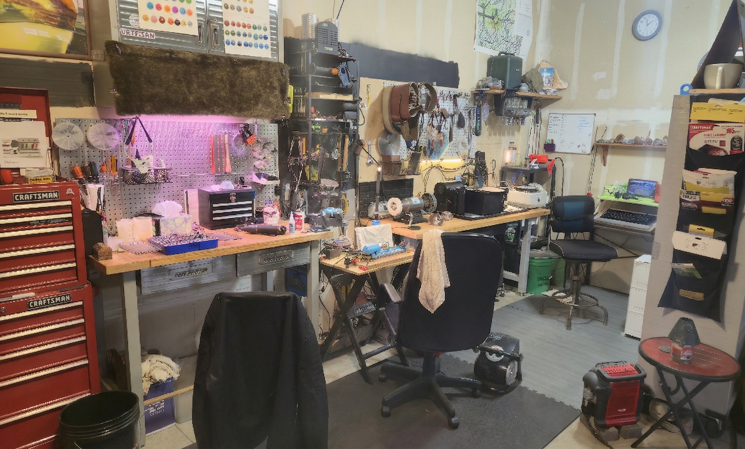 A cluttered workshop with workbenches, tools, and equipment for crafting or repairing, including a red toolbox, pegboard with supplies, and a whiteboard on the wall.