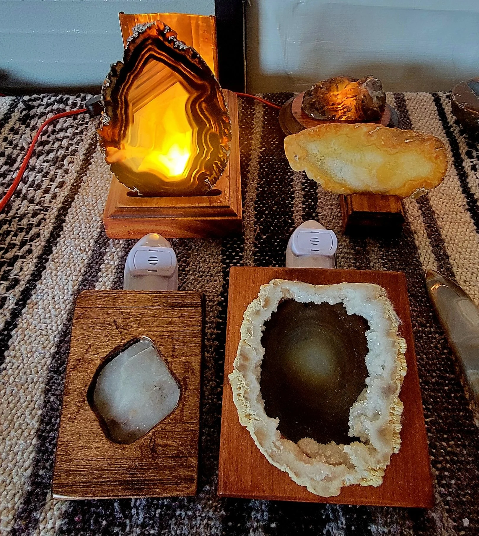 Several large polished stones in wooden frames serving as nightlights.