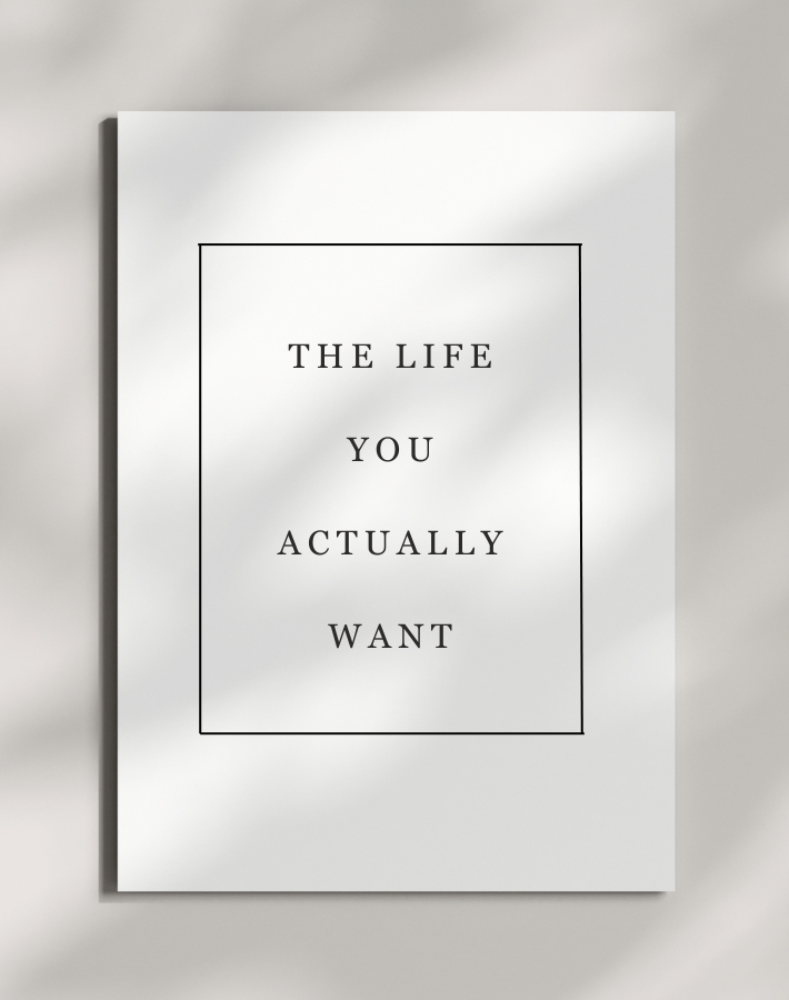 Worksheet with the quote 'The life you actually want' in black text, framed by a thin black rectangle, placed on a light-colored surface.