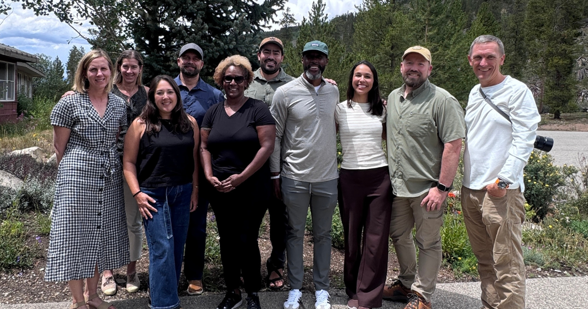 Colorado Outdoors Strategy partners standing together outdoors in front of pine trees