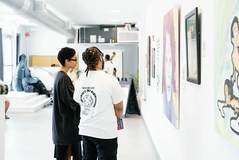 Visitors view artwork at a Baltimore community art gallery