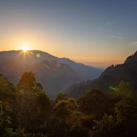 Begin each day with breathtaking sunrises over the misty mountain landscape.