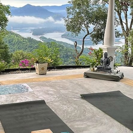 Morning yoga and meditation overlooking the misty mountains and Lake Victoria at Welikande Estate.