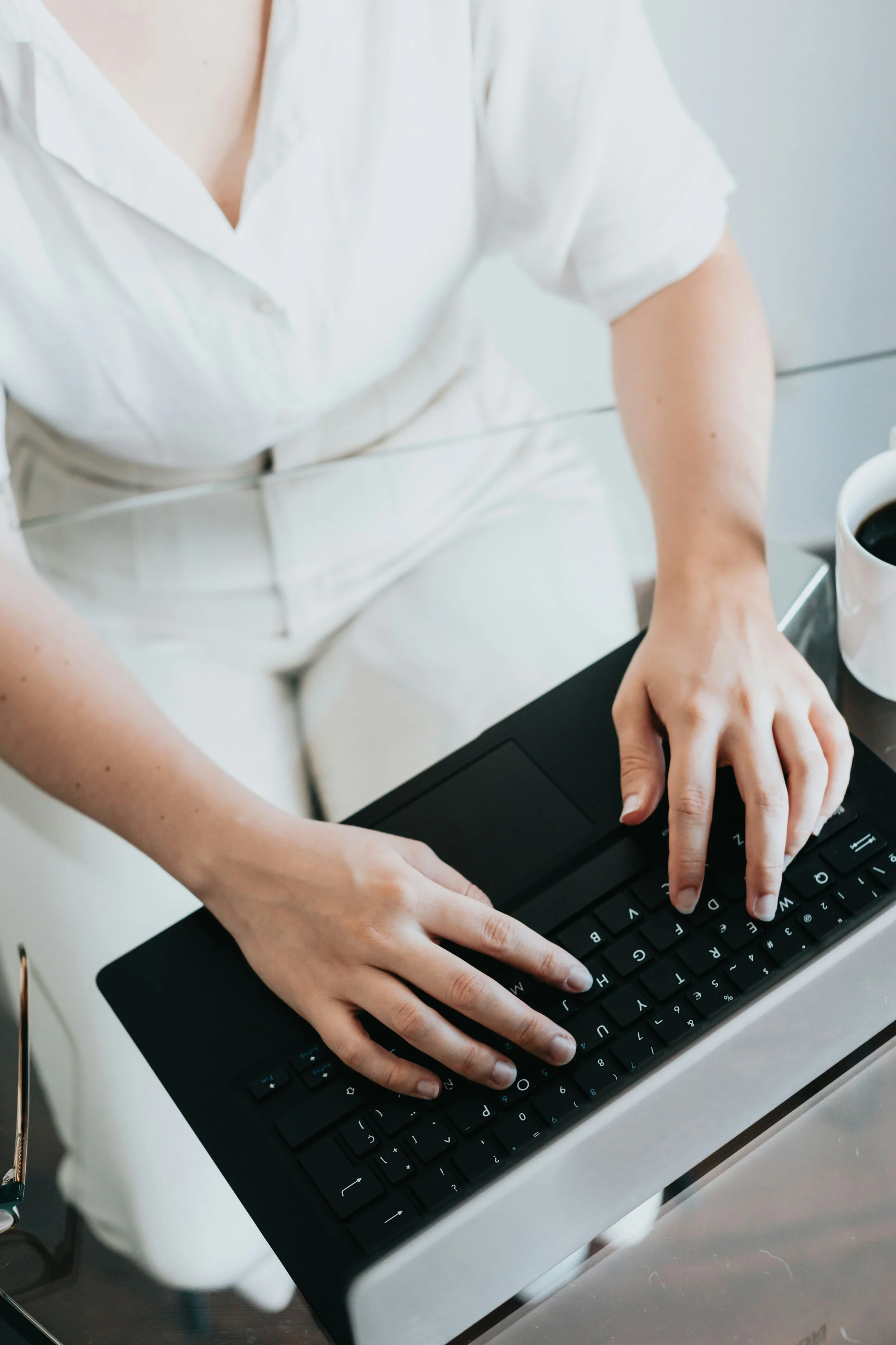 A woman's hands on a keyboard