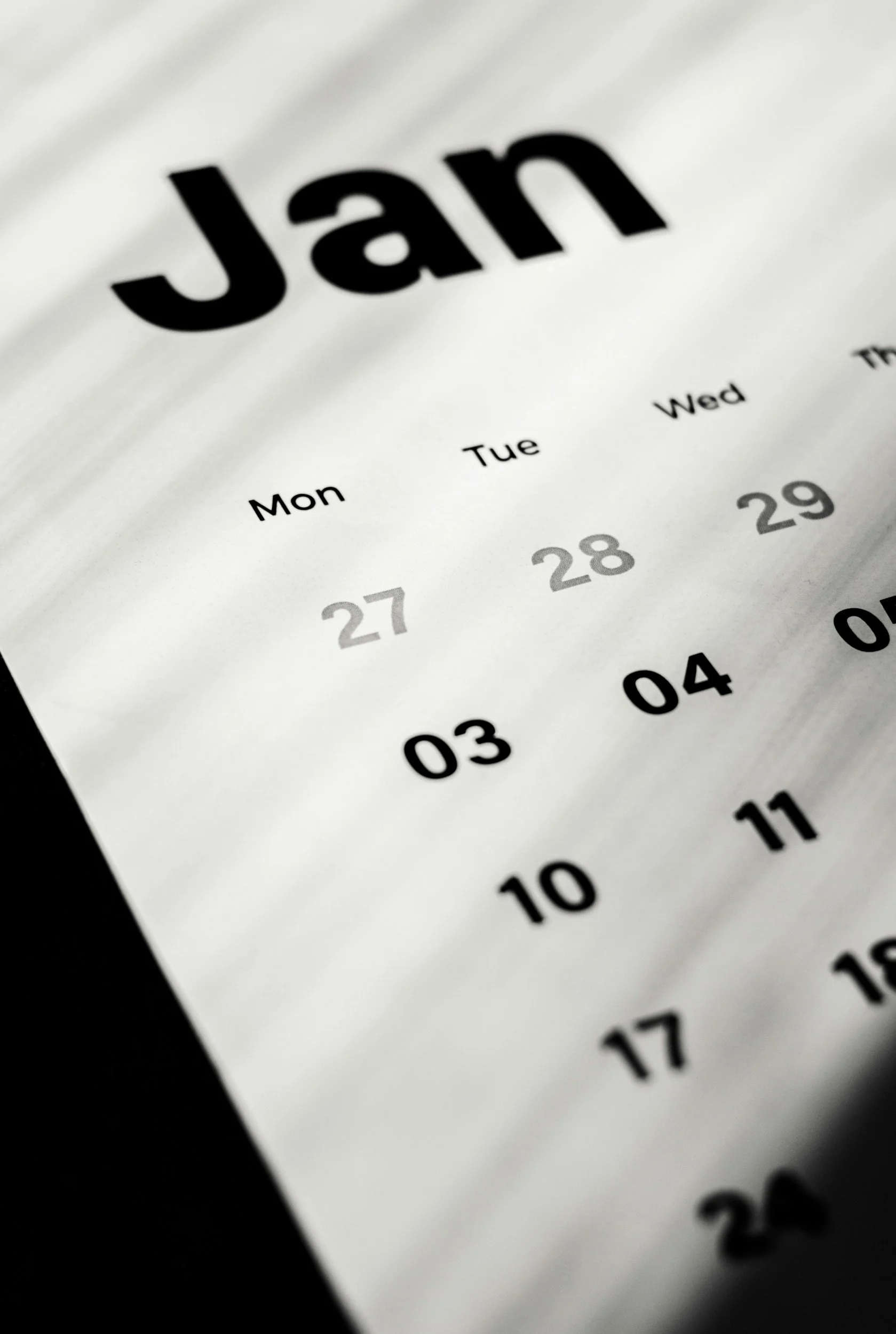 Close-up of a paper calendar page showing the month of January with various dates.