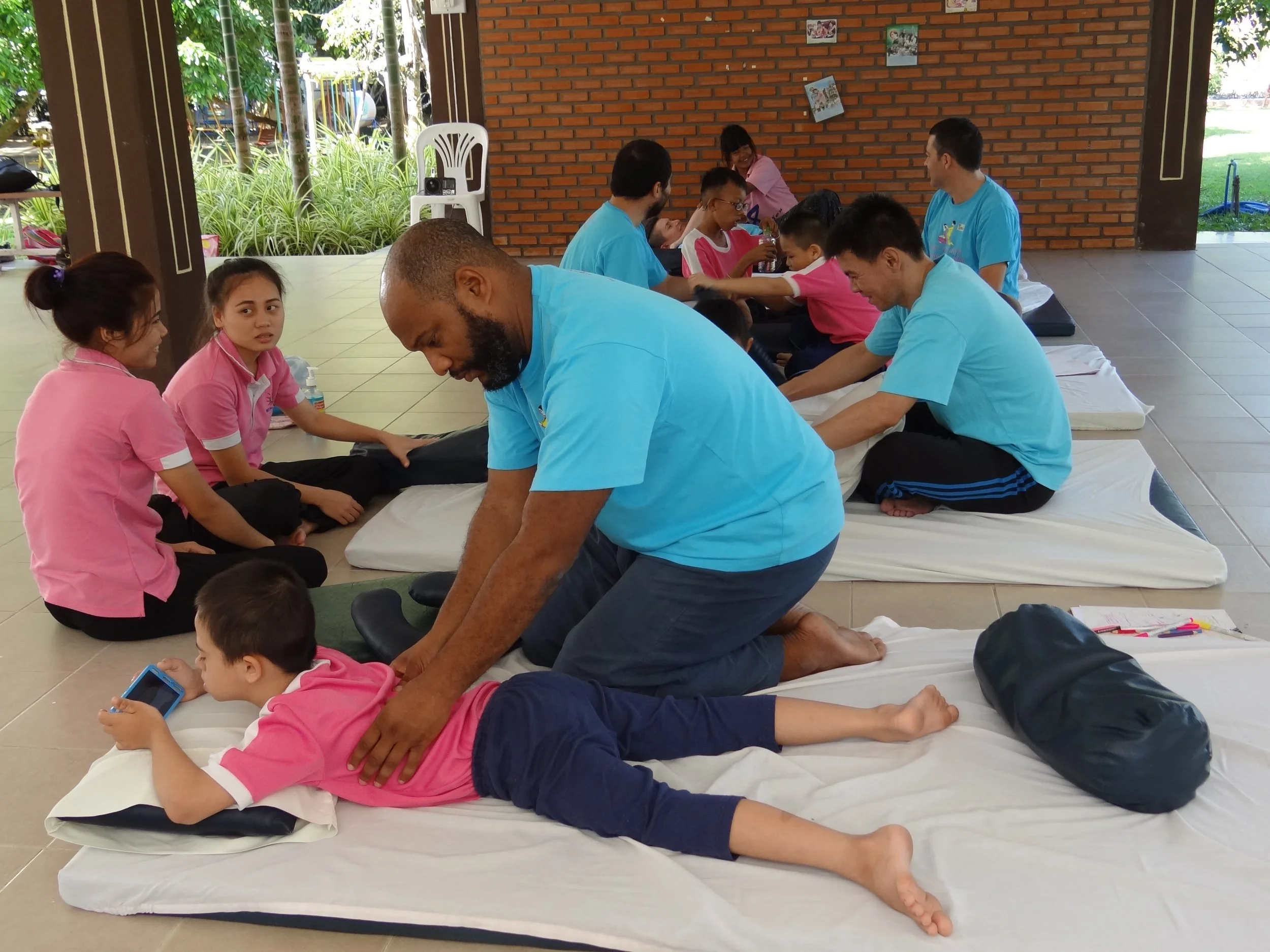 Therapeutic massage training session with children at TMC School in Chiang Mai