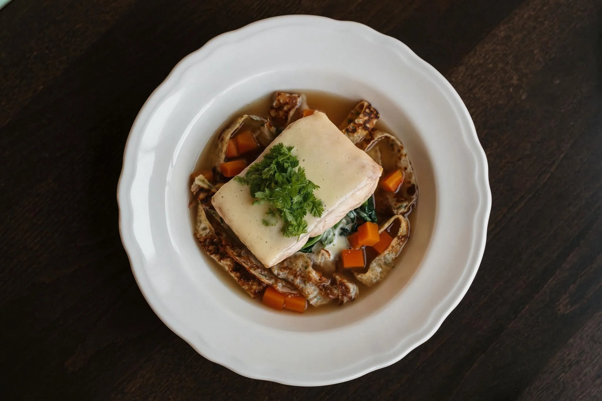 Our Wild Lake Trout, served over a bed cr&ecirc;pes C&eacute;lestine and consomm&eacute; finished with hollandaise and chervil.

We look forward to seeing you soon!

📷: @ellengustafsonphoto