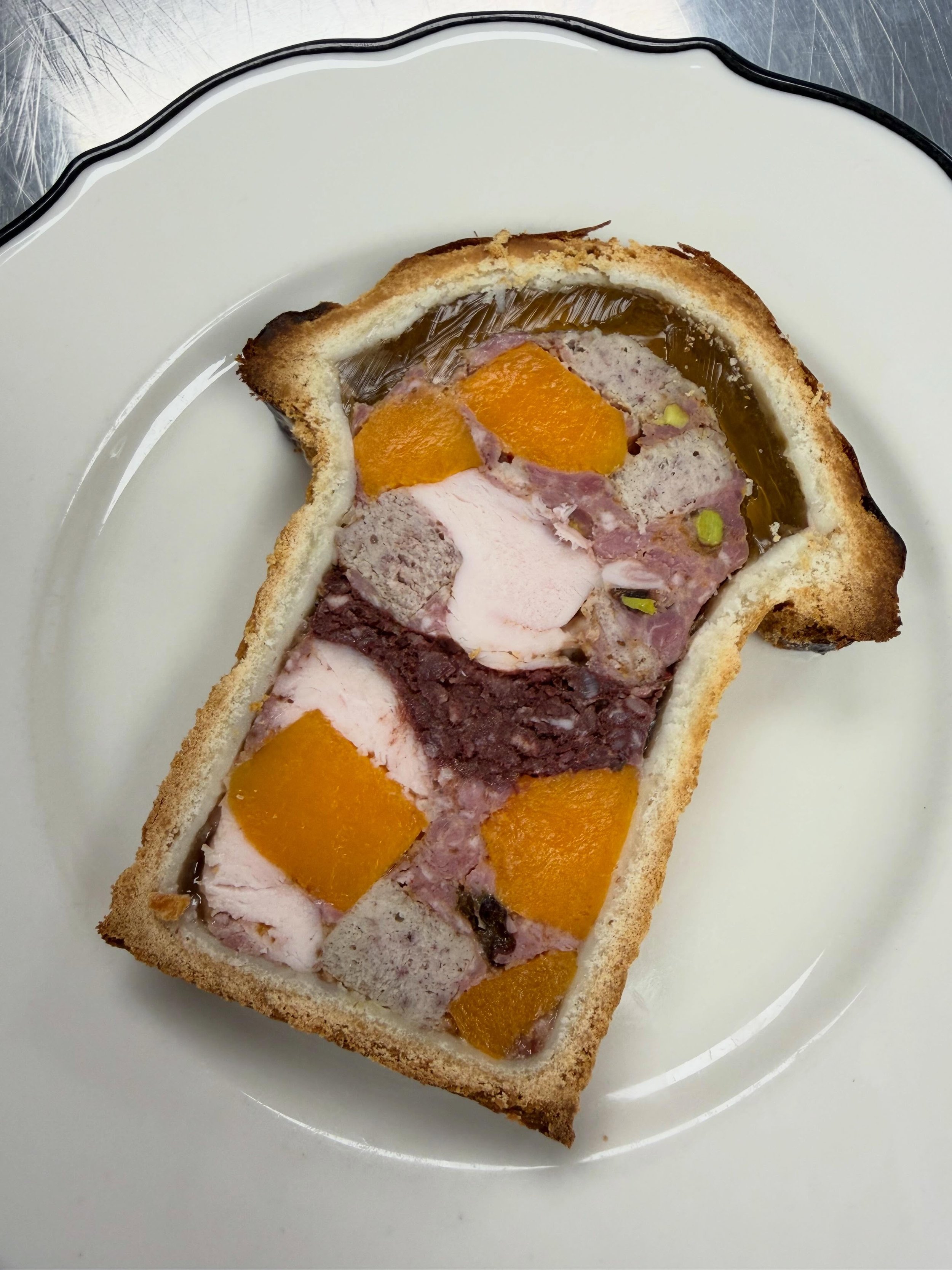P&acirc;t&eacute; en Cro&ucirc;te remains a constant on our ever changing menu, although the inclusions change regularly. We are happy to highlight Minnesota ingredients while paying homage to the old world French technique. 
Our current iteration in