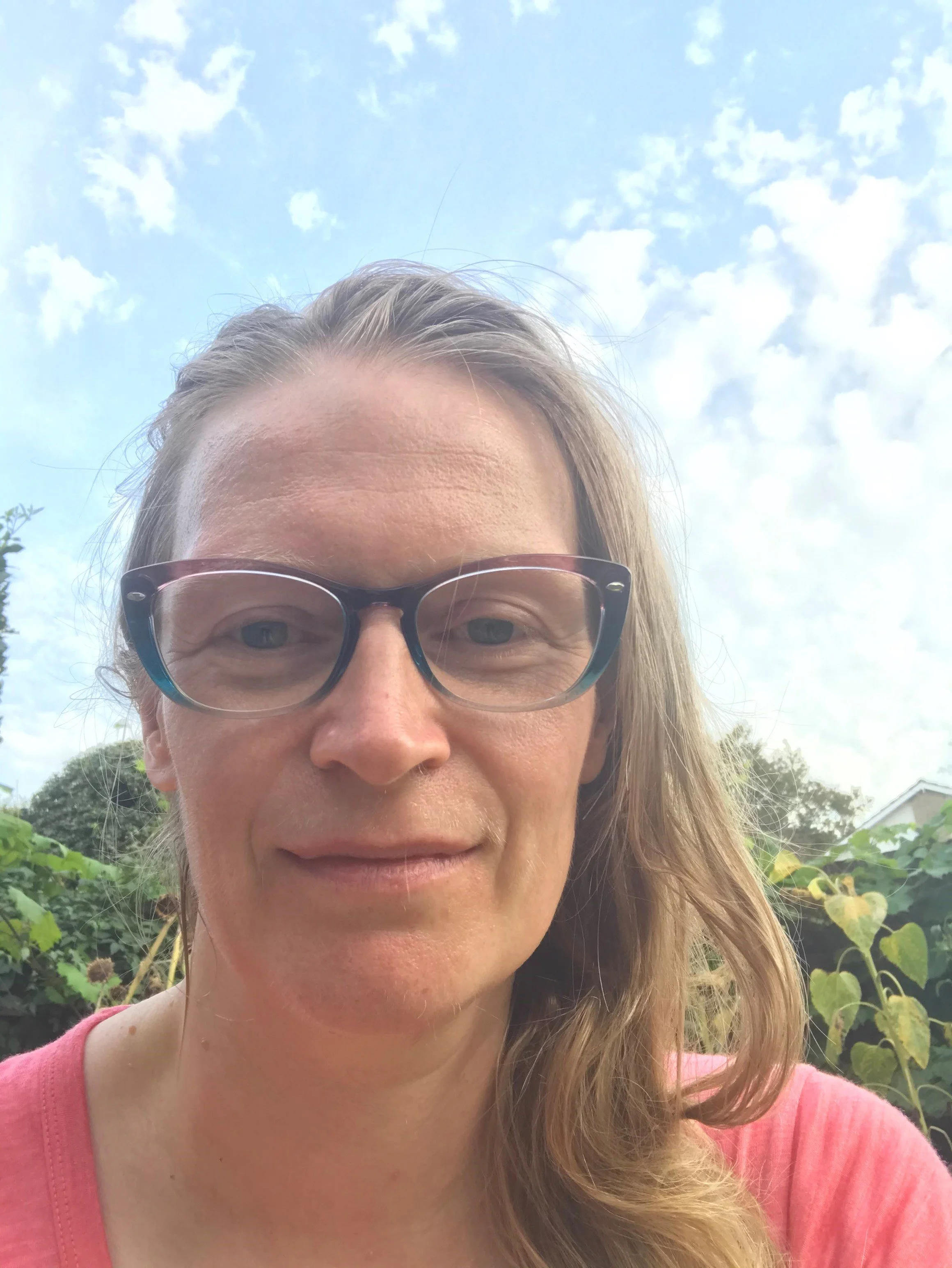 A headshot of Ms Eleanor Jane Turner who has long hair and is wearing glasses
