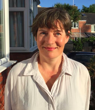 Headshot of Prof Ginny Russell who is wearing a white shirt and is smiling