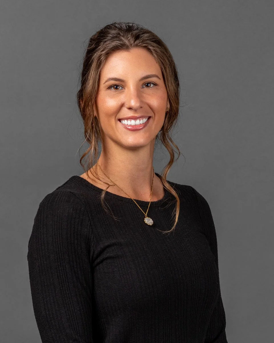 Logo with a dark blue scalloped circular background, featuring a white letter A overlayed with the Greek letter alpha.