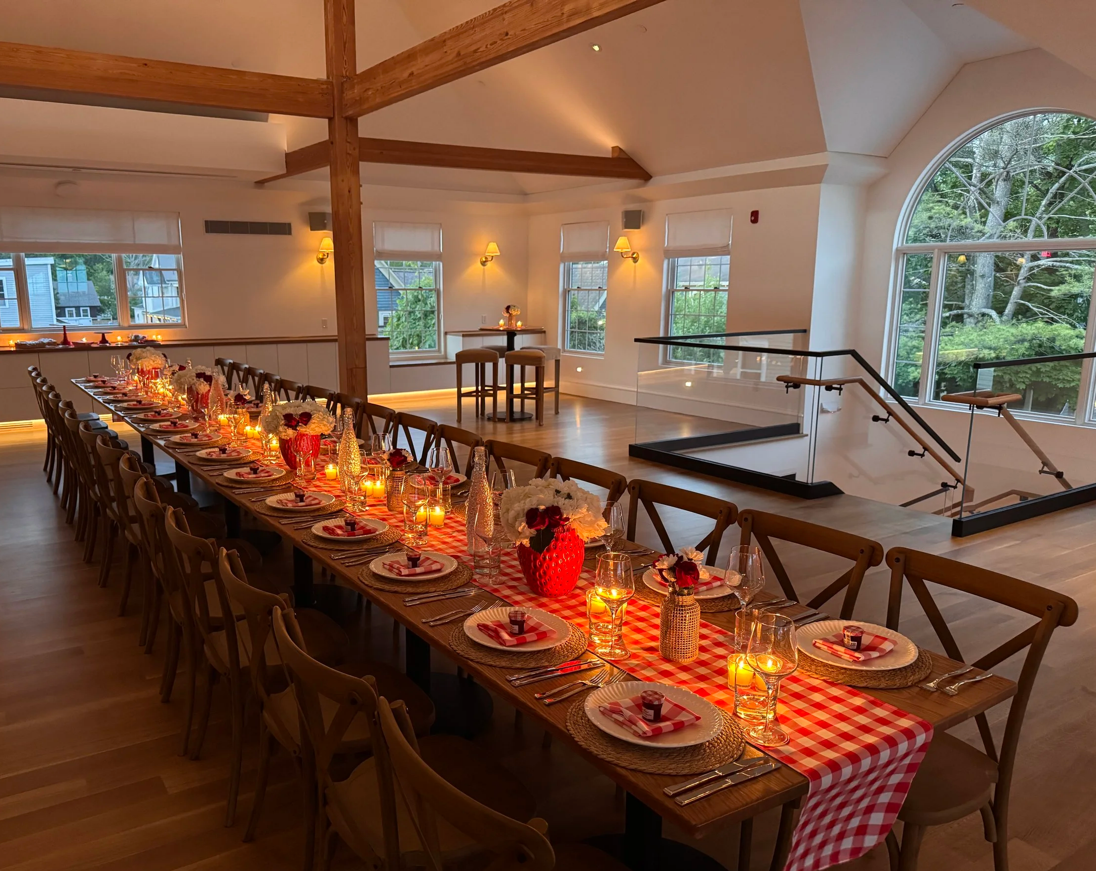 As the sun sets, the main level is set for a small dinner party with a dessert bar and buffet tables. 