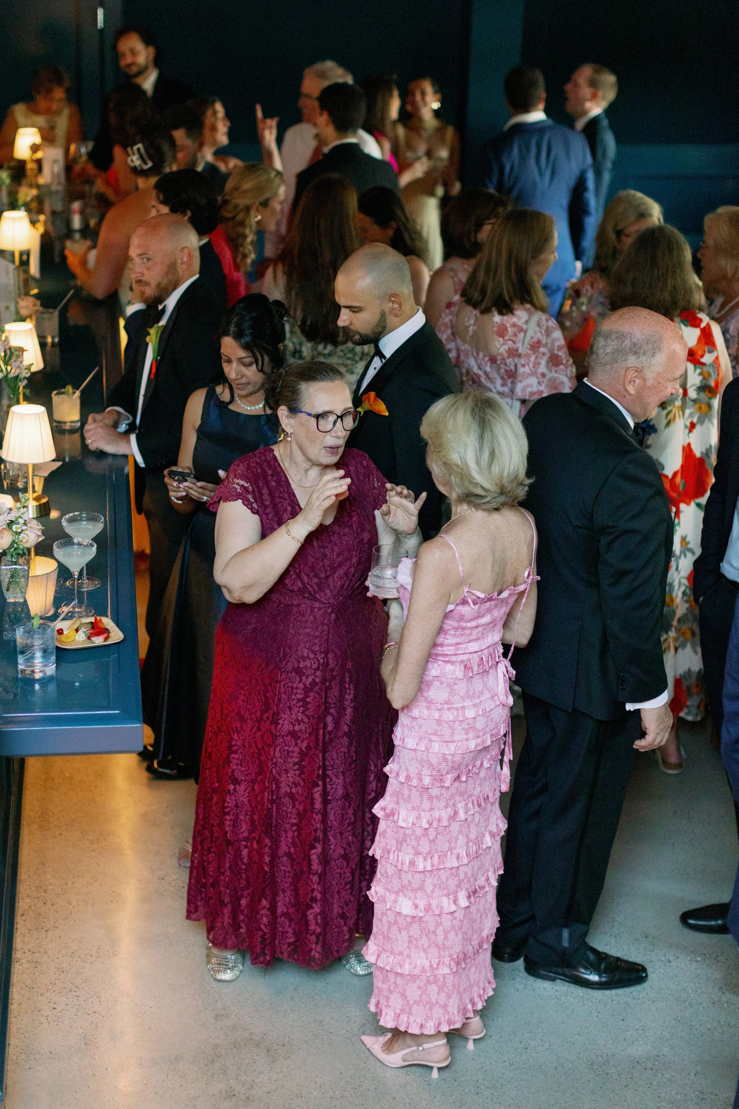Downstairs, the bar is hopping before a wedding reception on the main level.