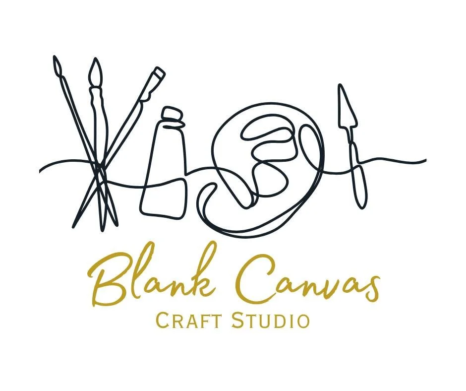 Logo for Blank Canvas Craft Studio, featuring a continuous line drawing of art supplies and a canvas, with the studio name written below in gold cursive and block fonts.