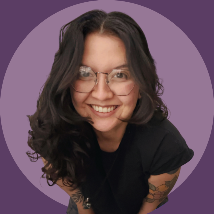 Tina Powell has long, dark curly hair, glasses, and tattoos, smiling and leaning forward. She is wearing a black shirt against a purple background with a circular vignette.