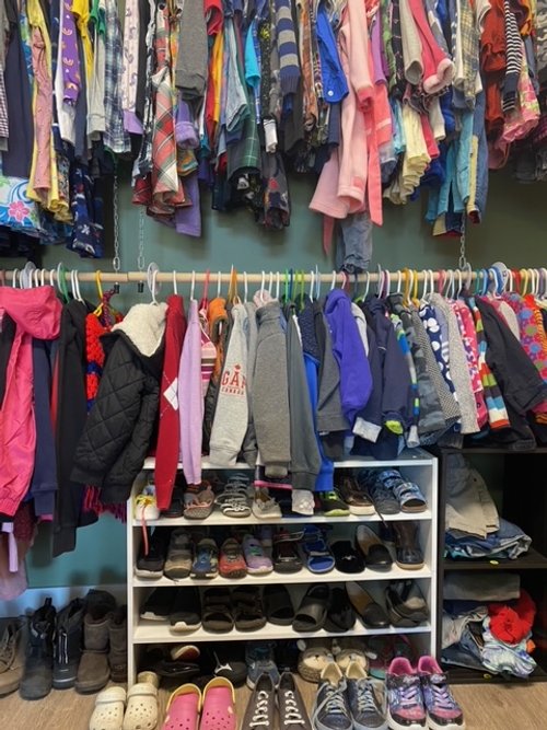 A rack of children's coats inside the boutique.