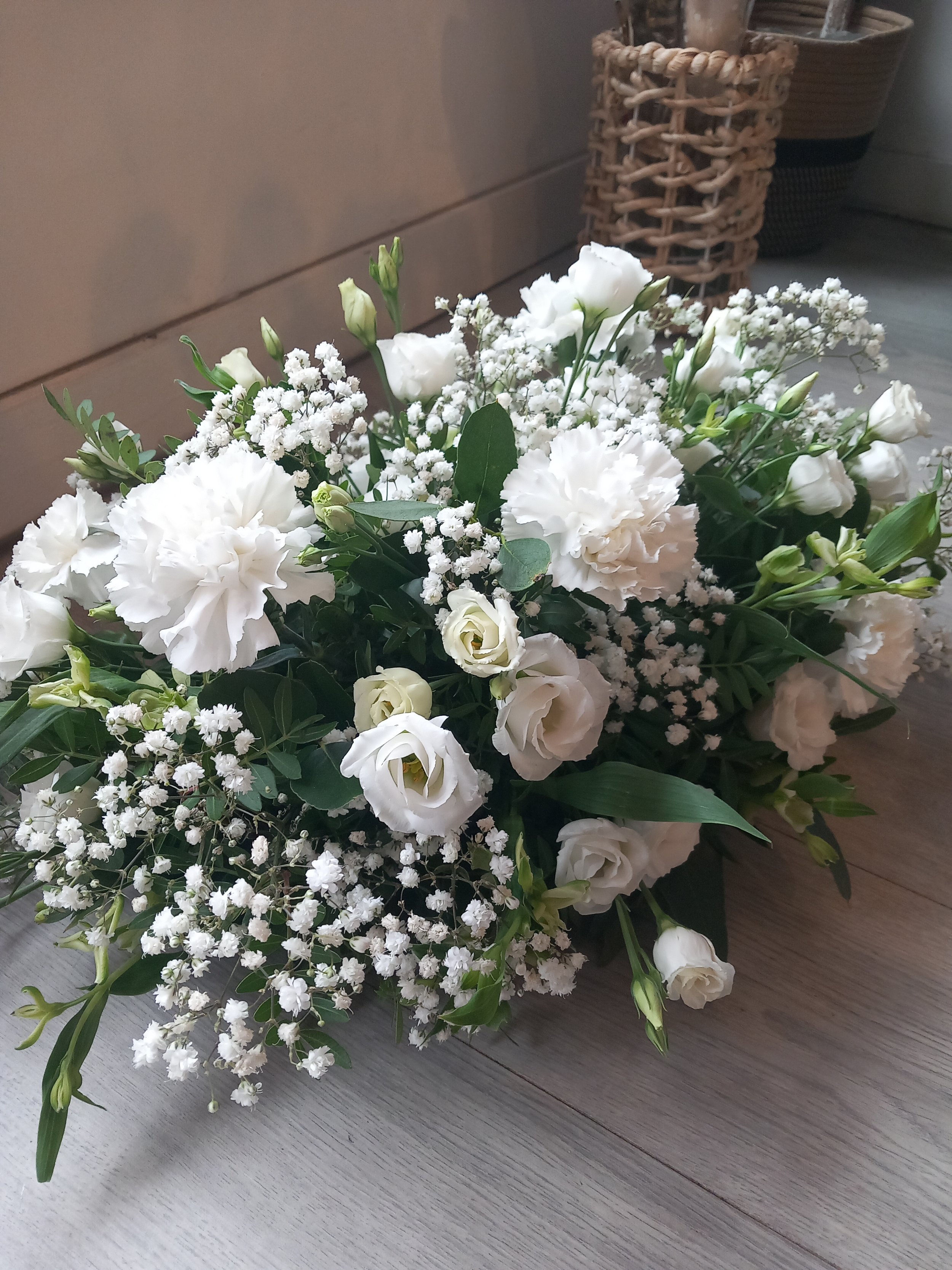 Wedding flowers of carnations, lisianthus, gyp, alsromeria and eucalyptus for a registry table and top table of a wedding service.