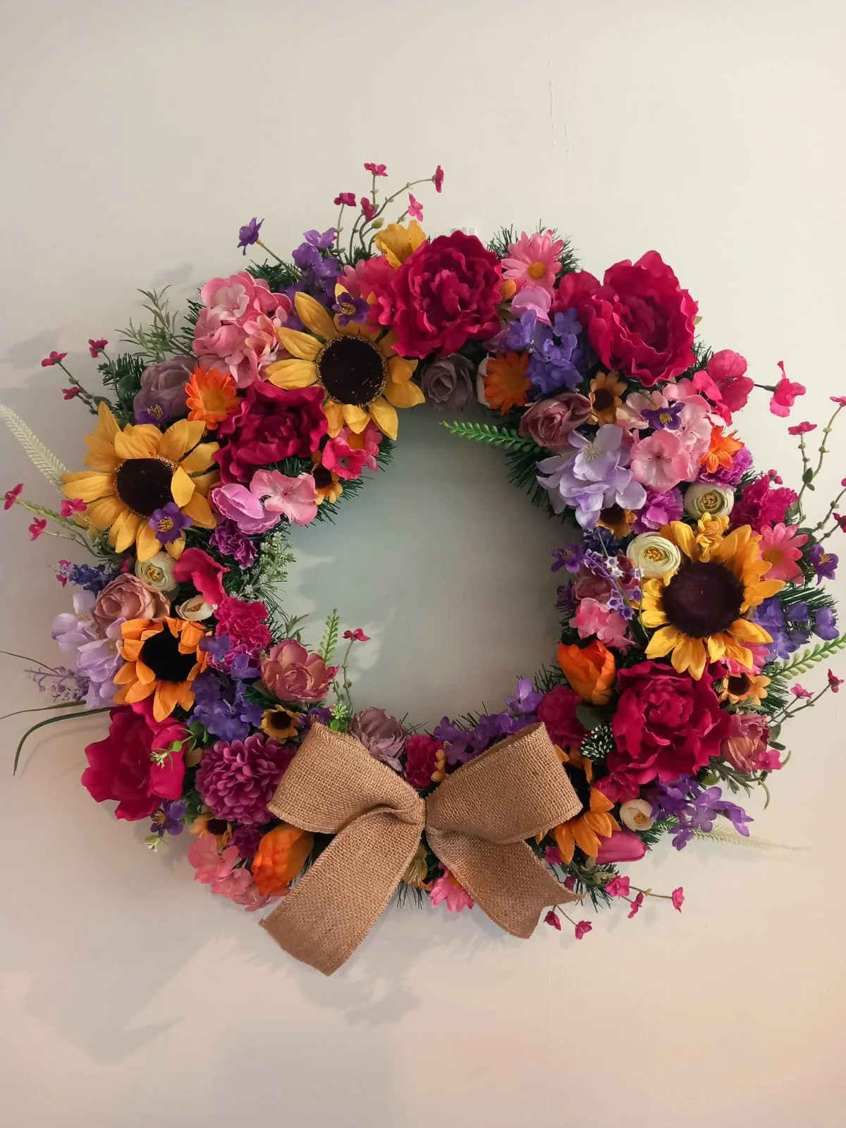 Colourful door wreath with faux flowers for summer