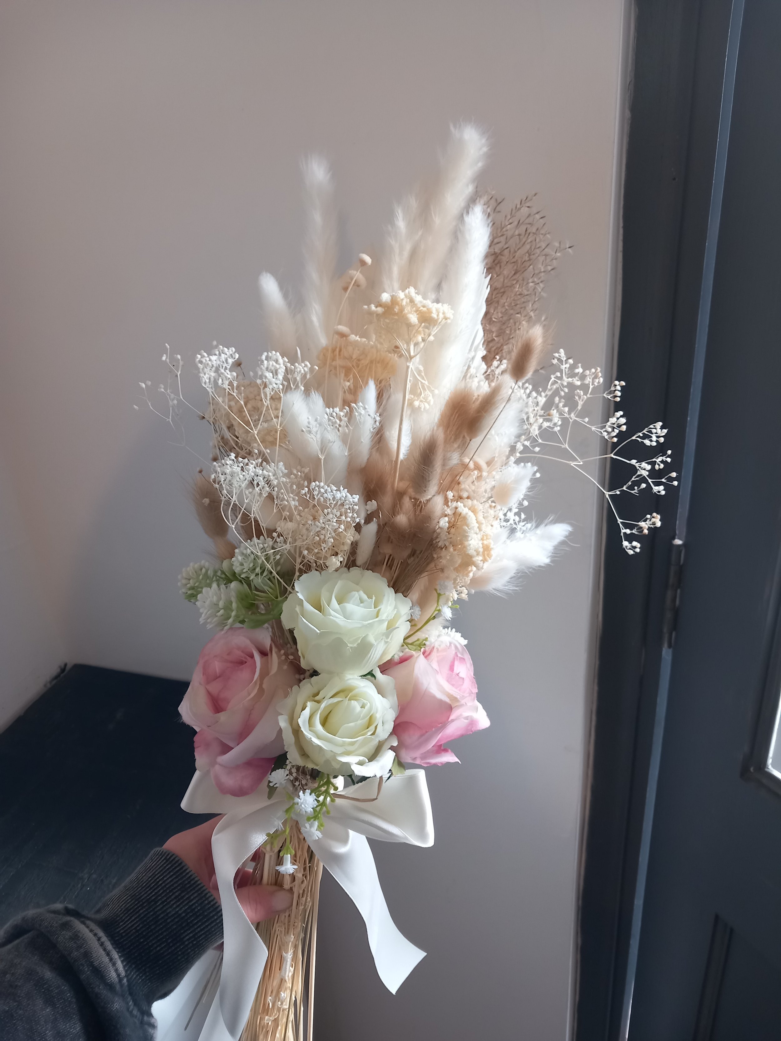 Dry flower bridesmaid bouquet for a dry flower wedding with brown and white pampas grass and bunny tail flowers with light pink roses