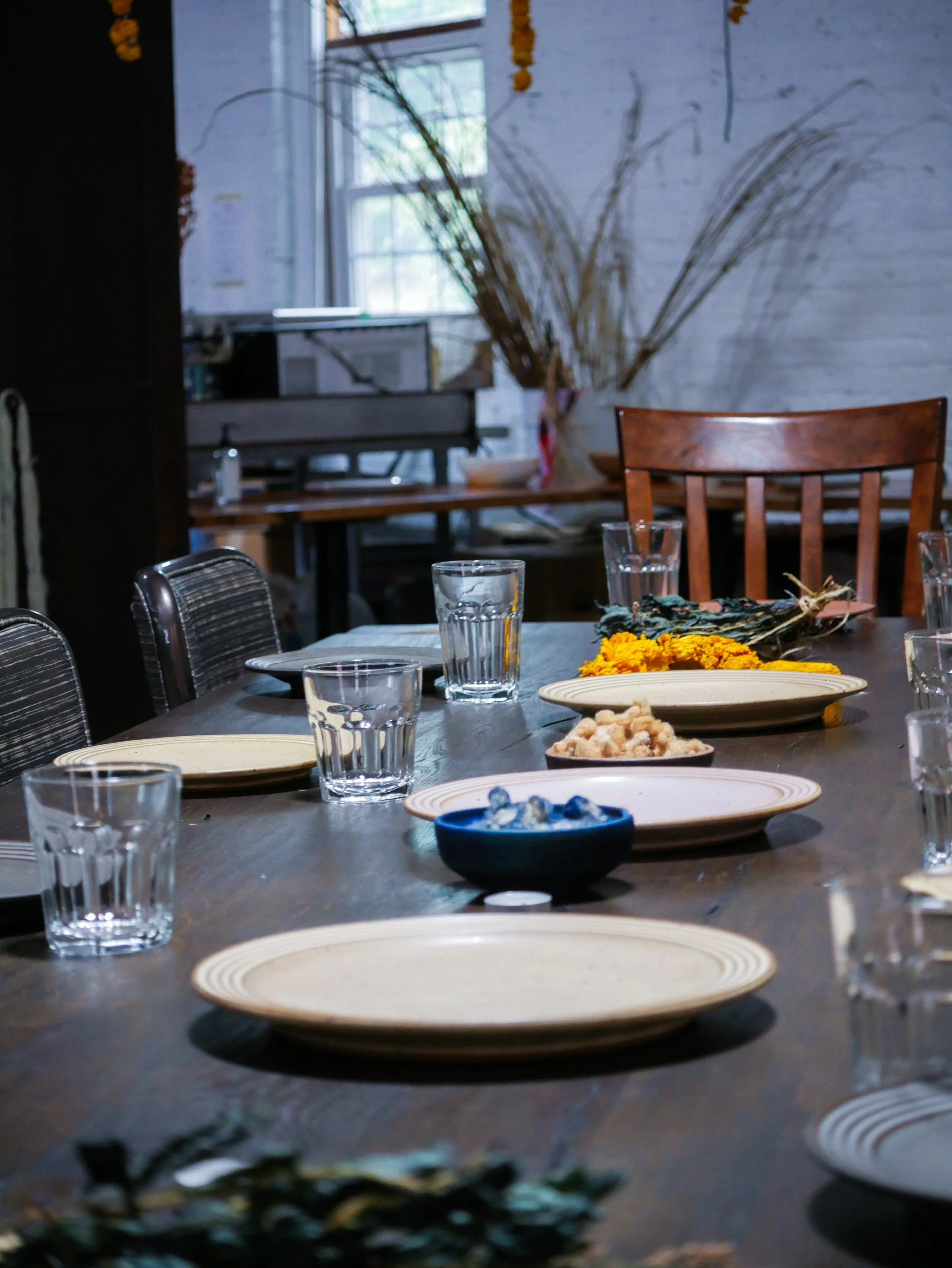 A table set for a community meal before participants arrive for a Mixing Bowl gathering.