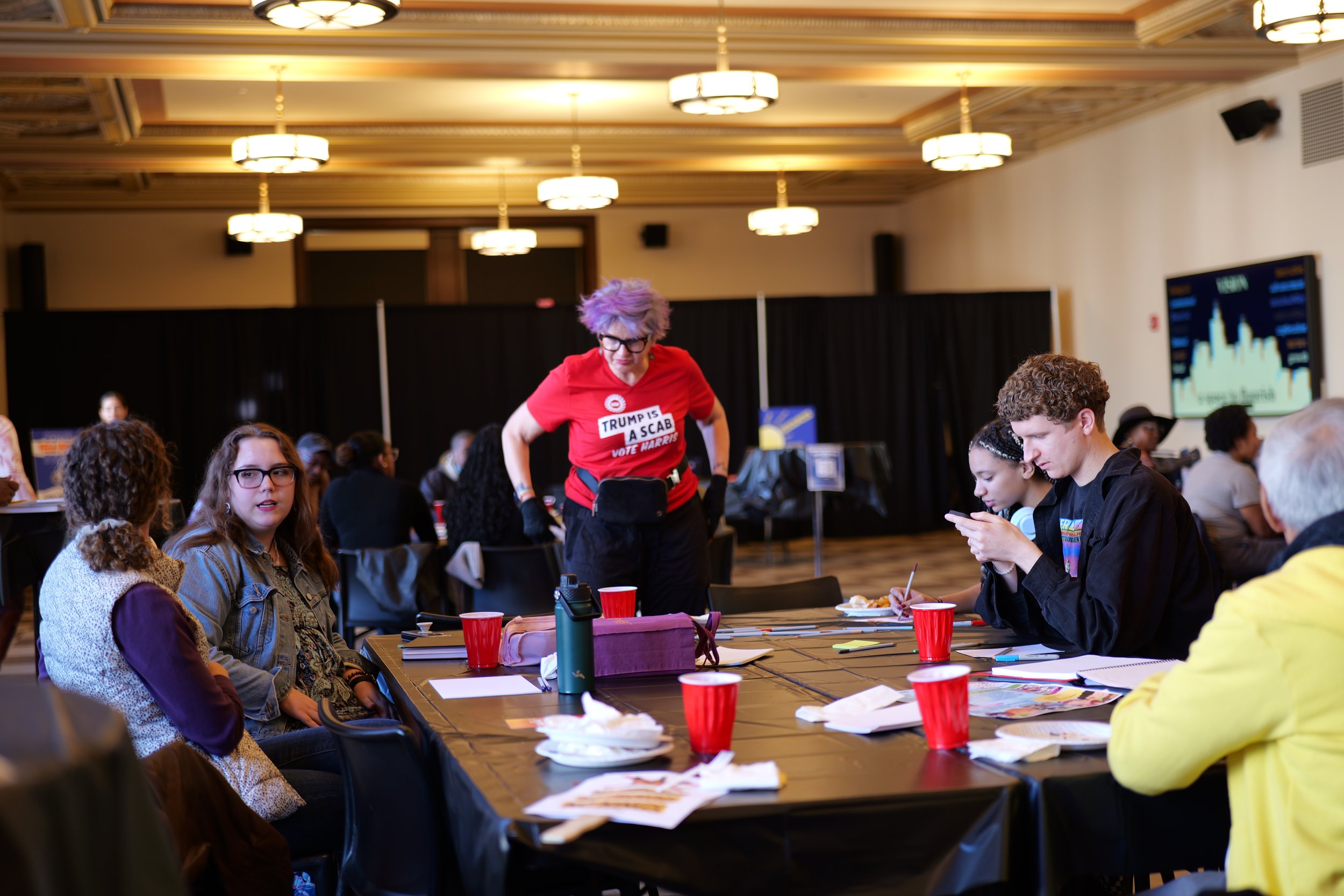 Participants gather around a table for conversation and storytelling during a Mixing Bowl event.
