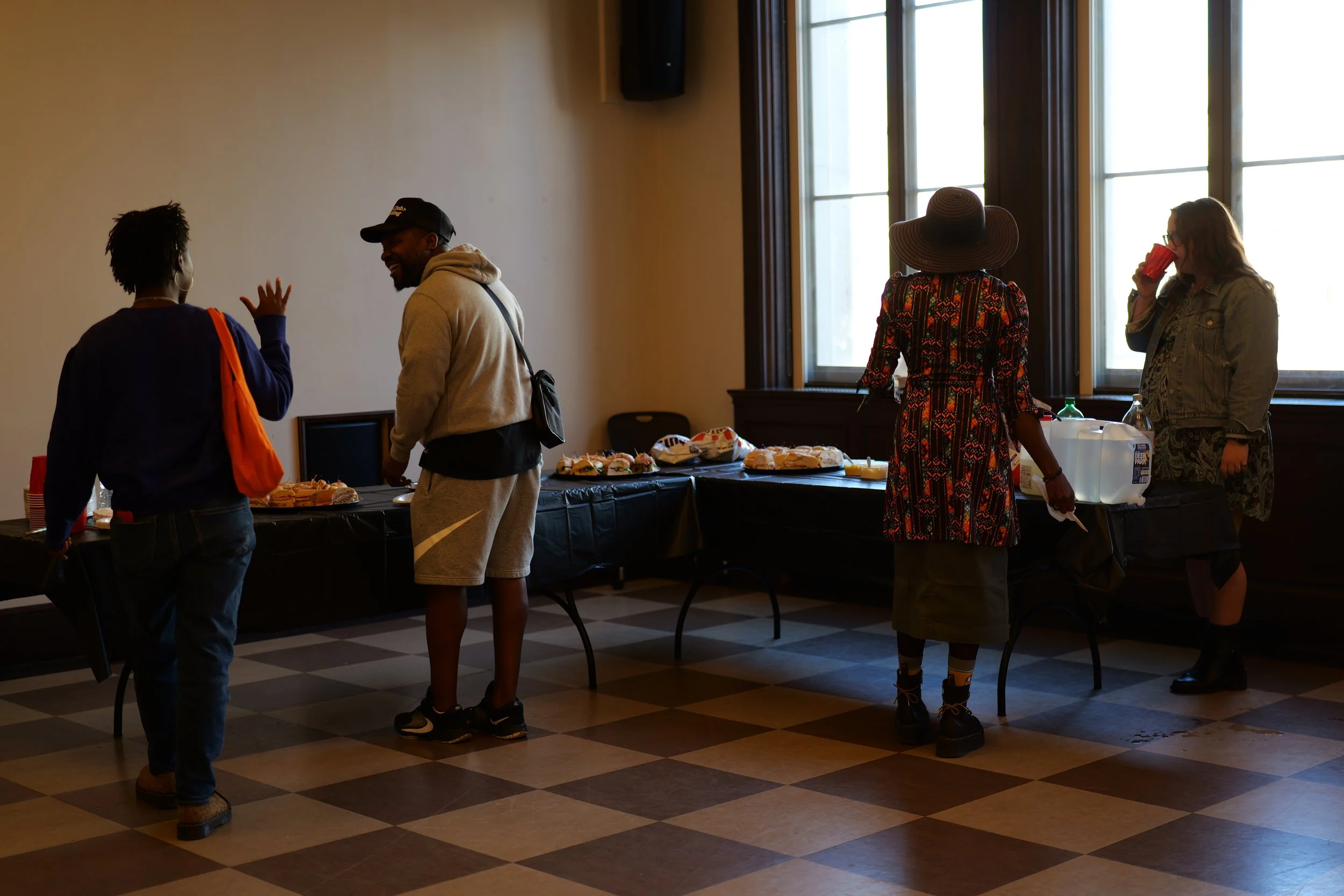 Community members gather and connect before a shared meal at a Mixing Bowl event.