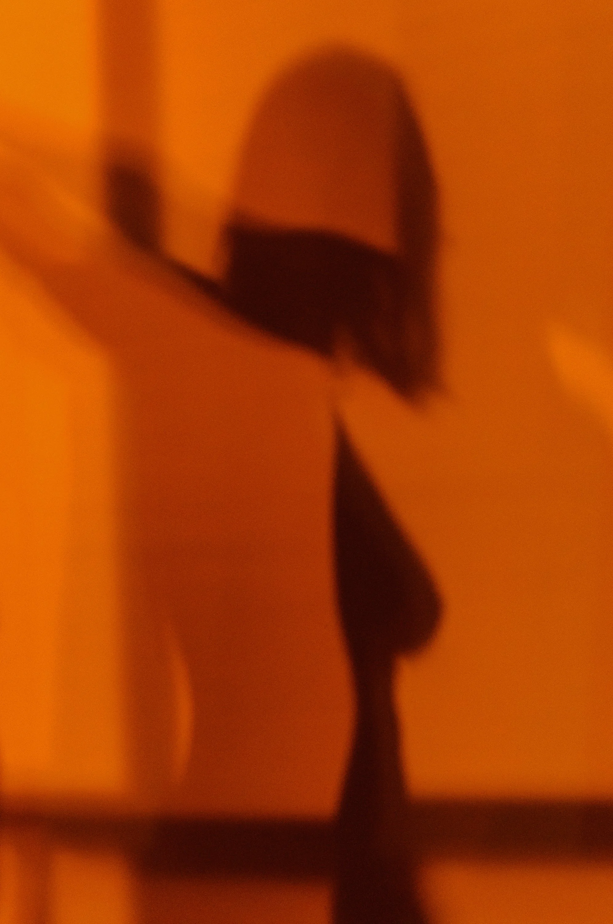 Woman's shadow in orange light