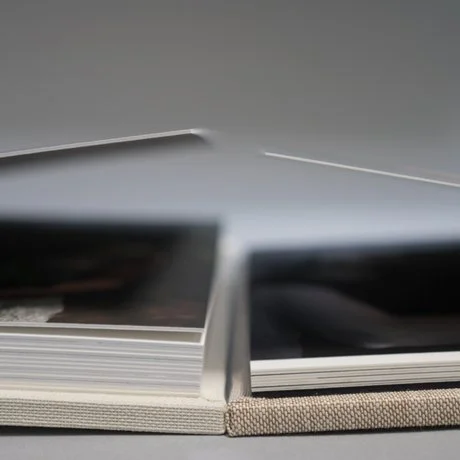 Close-up of an open photo album with thick pages.