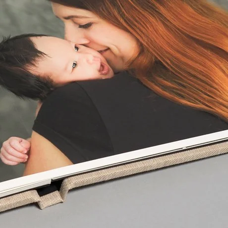 Photo album showing a woman with red hair holding a baby