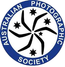 Logo of the Australian Photographic Society featuring a circular design with stars and a camera shutter pattern.