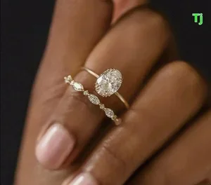 Person packaging gold jewelry for secure online shipment to a trusted gold buyer with calculator and documents on table.