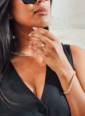 Person holding a gold necklace while checking its resale value