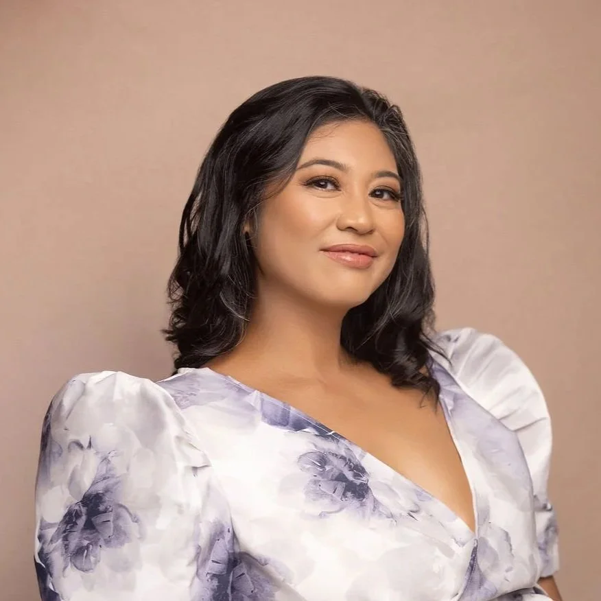 A Filipina American with black hair and a floral terno