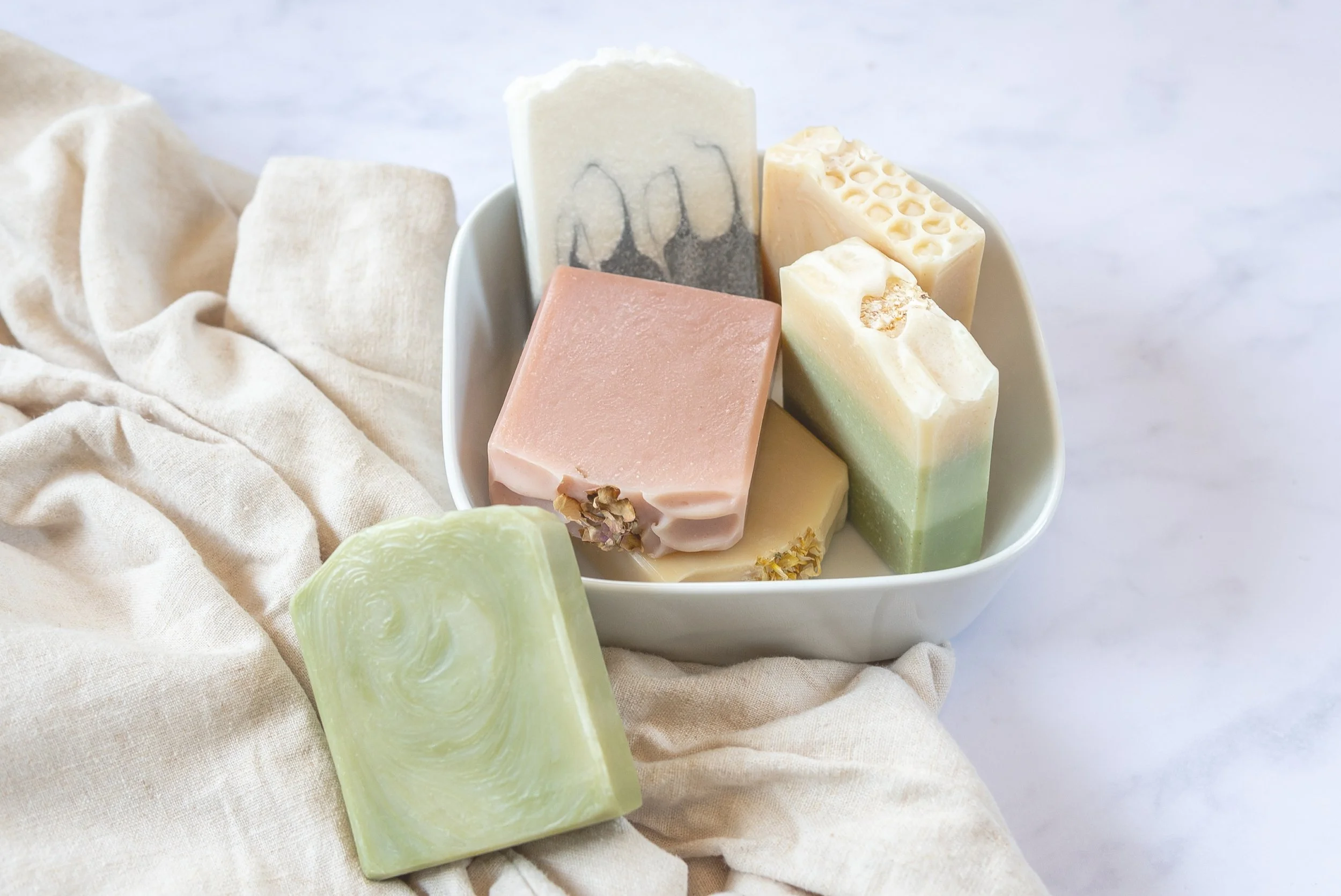 Handmade natural soap bars in a variety of colours and botanical designs
