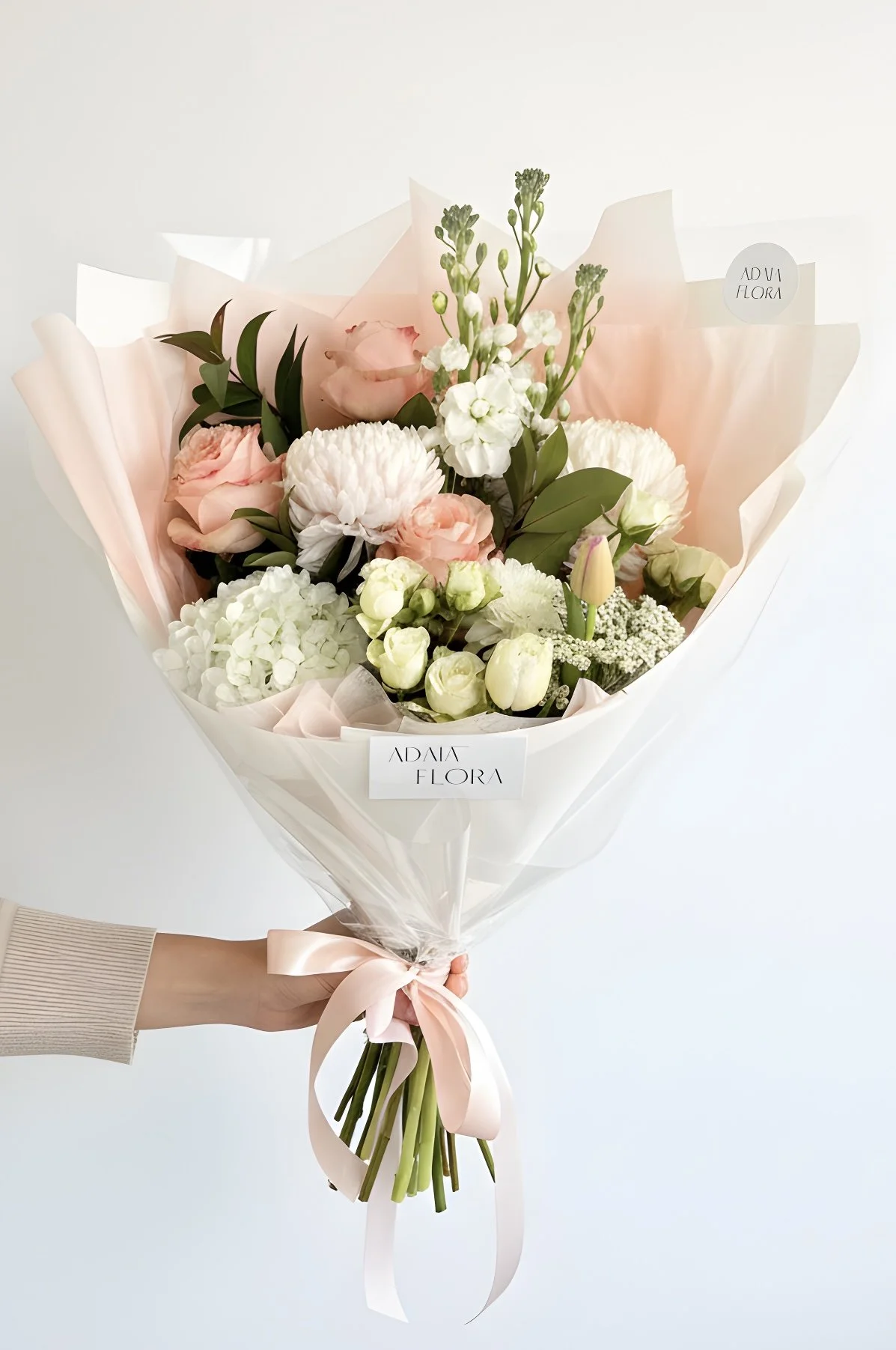 Hand holding Mother's day bouquet in Hamilton NZ, by Florist Adaia Flora.