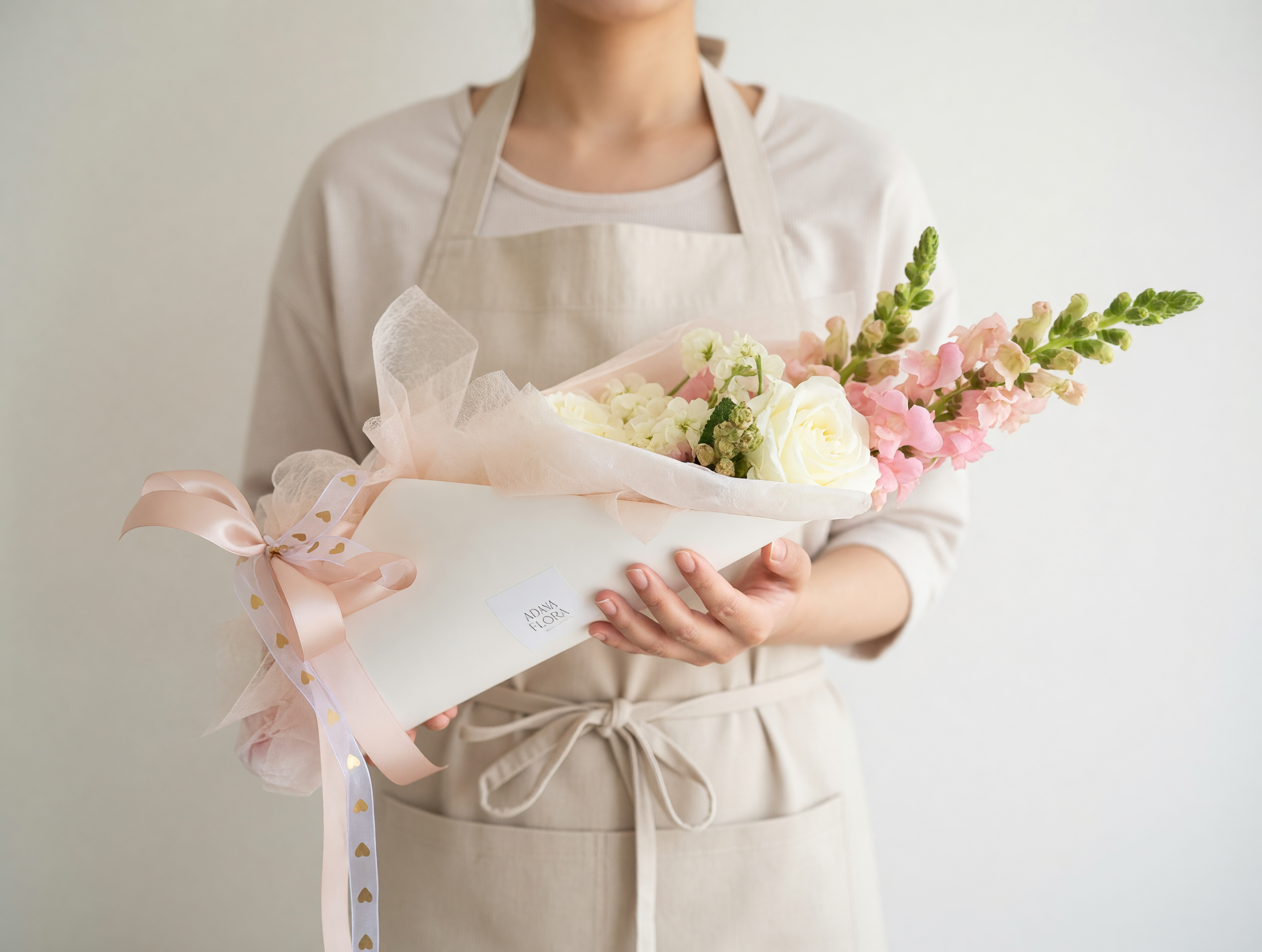 Mother's Day flower carrier with fresh blooms in soft pastel tones, beautifully arranged for gifting in Hamilton NZ.