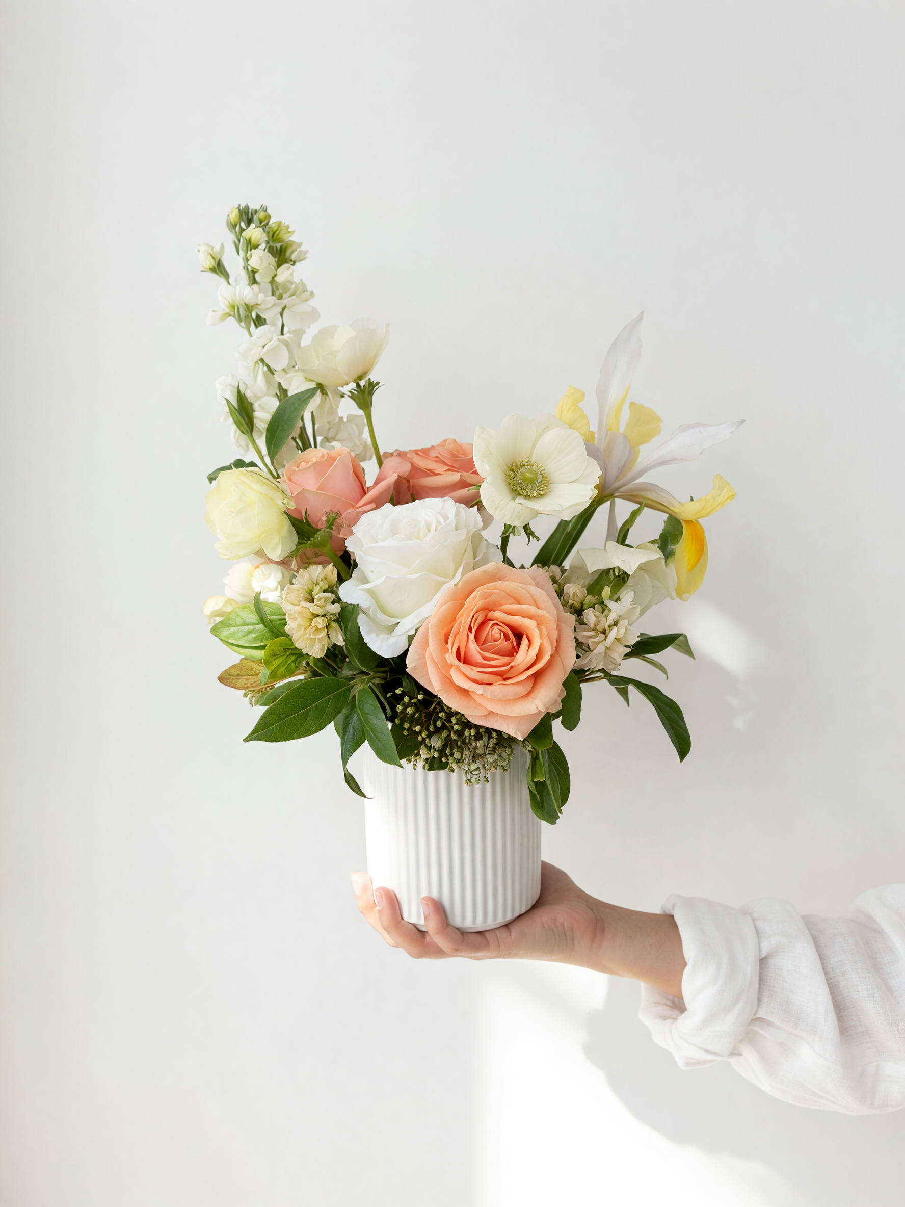 Small potted arrangement in soft blues,yellow,white and peach tones included in the Blue Skies gift hamper by Adaia Flora