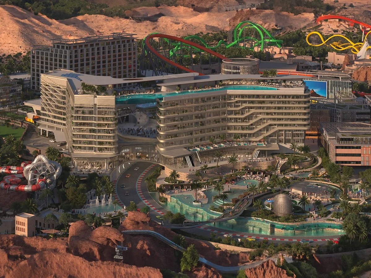 A futuristic resort with multiple water parks, slides, a large hotel with a rooftop pool, and surrounding desert landscape and mountains in the background.