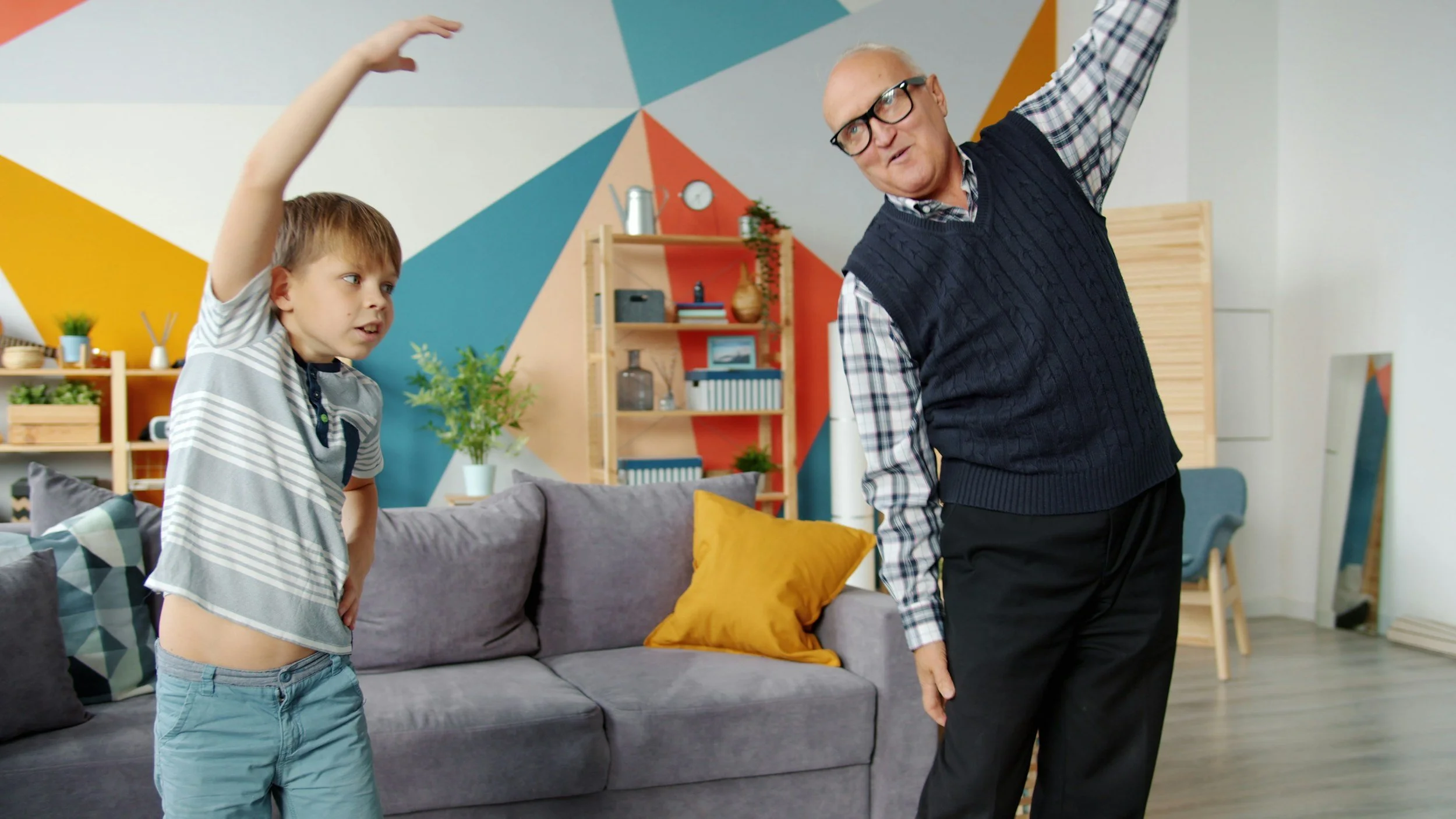 Family dancing together in living room during virtual dance lesson