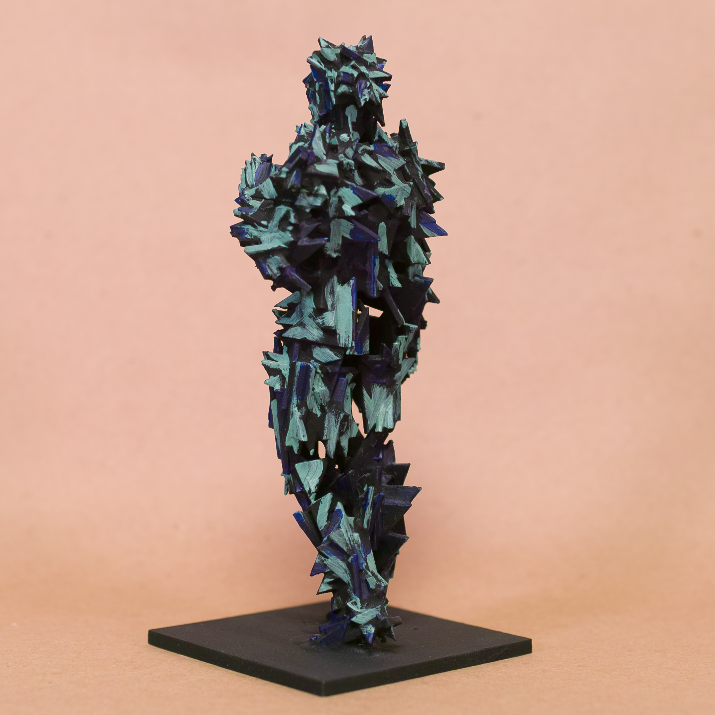 Contrapposto Doryphoros sculpture reimagined: fragmented jagged shard armor in black with iridescent blue-teal glints, brooding sentinel on black base by Mark G. Taber