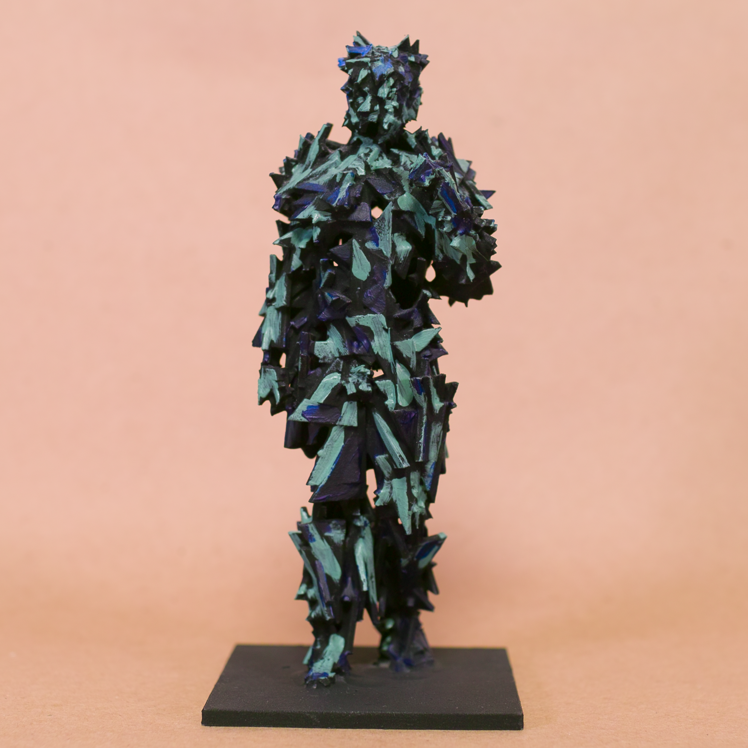 Contrapposto Doryphoros sculpture reimagined: fragmented jagged shard armor in black with iridescent blue-teal glints, brooding sentinel on black base by Mark G. Taber