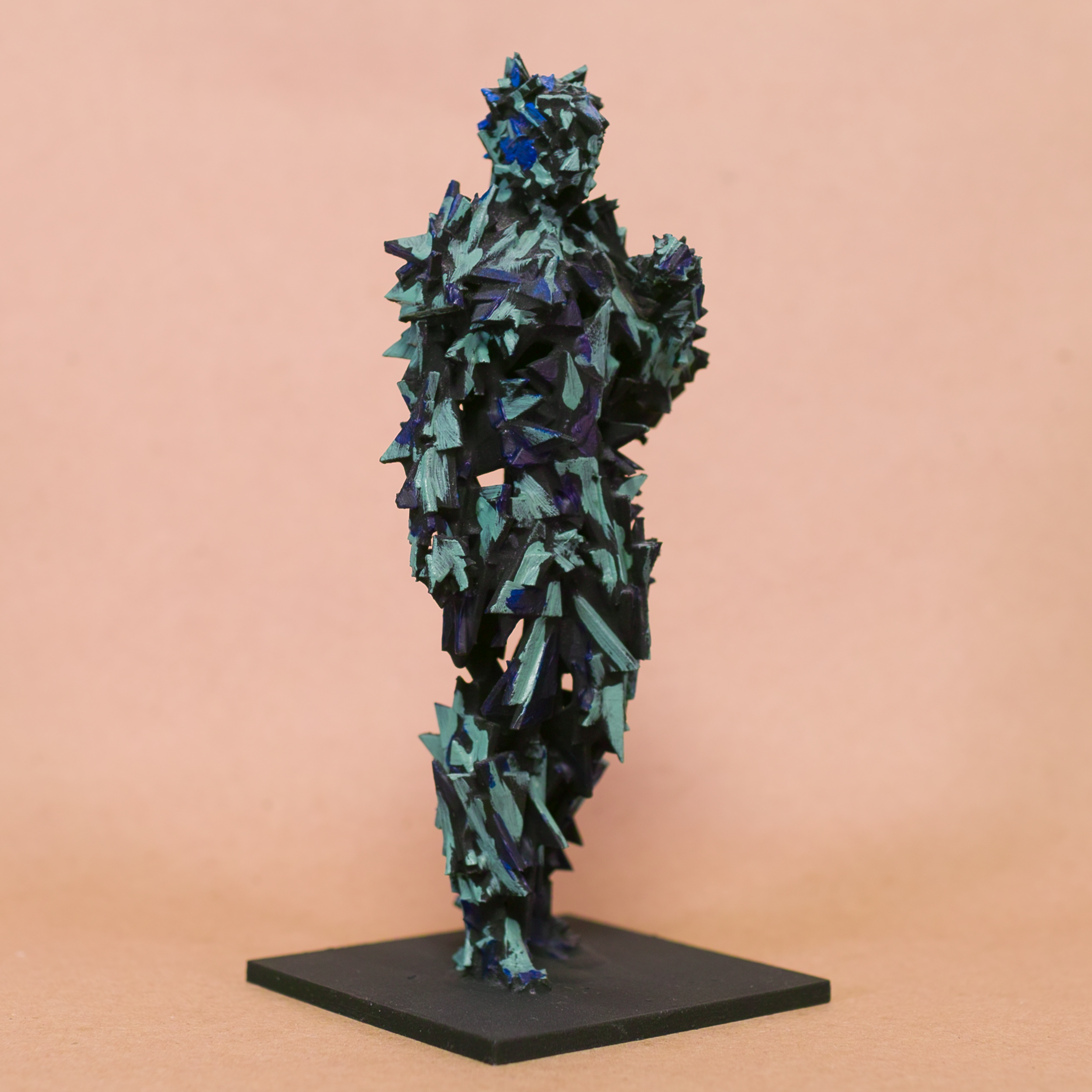 Contrapposto Doryphoros sculpture reimagined: fragmented jagged shard armor in black with iridescent blue-teal glints, brooding sentinel on black base by Mark G. Taber