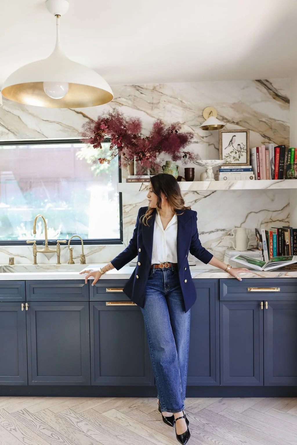 interior designer standing a well designed kitchen